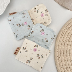 Detail of floral corduroy coin purse with snap closure and soft fabric texture
