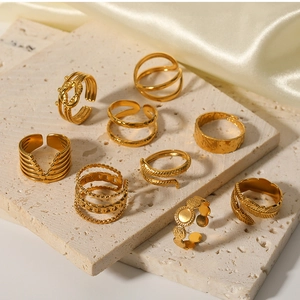 Detailed arrangement of 18k gold plated stainless steel irregular rings on stone base
