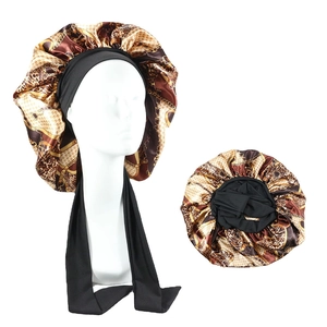 Detail of satin hair bonnet with leopard print, chain pattern and wide elastic band