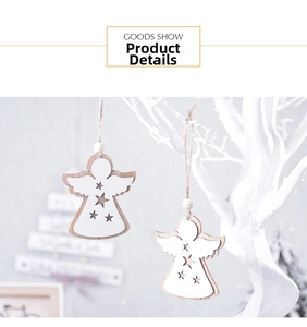 Detail showing two wooden angel Christmas ornaments with star cutouts on a white tree