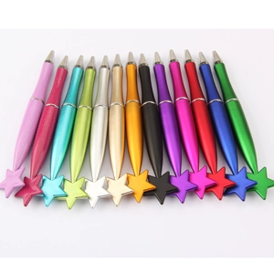 Row of colorful metallic ballpoint pens with star-shaped caps on a clean white background