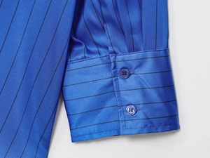 Detailed macro of blue striped shirt cuff featuring a classic double-button closure design