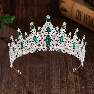Close-up of silver bridal crown featuring brilliant clear and green crystal stones