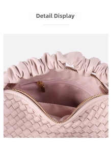 Detailed view of the woven pink leather bag interior with gold zipper and ruffled handle