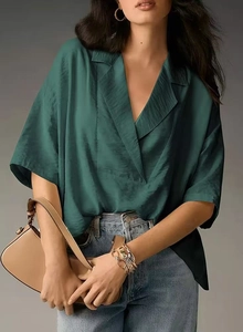 Detailed texture of dark green satin short sleeve shirt with smooth silky luster
