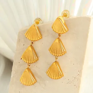 Three-layer shell drop earrings in brushed gold with extra steel and silicone backs