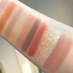 Arm swatches of 26-color eyeshadow palette with matte, shimmer, and glitter textures