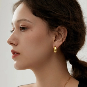 Elegant 18K gold-plated stainless steel teardrop earrings on a female model
