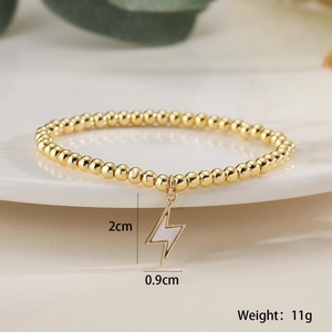 Macro shot of 18K gold plated beaded bracelet with lightning bolt pendant and dimensions