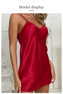 Detail of dark red satin slip nightdress showing fine straps and silk-like V-neck fabric