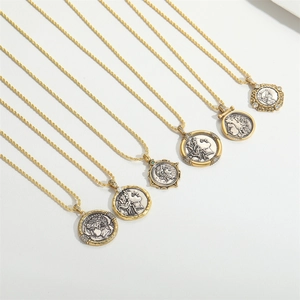 Close-up of vintage gold and silver coin pendants with Greco-Roman embossed portraits