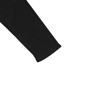 Close-up of the black corduroy ribbed cuffs on a men's long-sleeve Henley baseball shirt