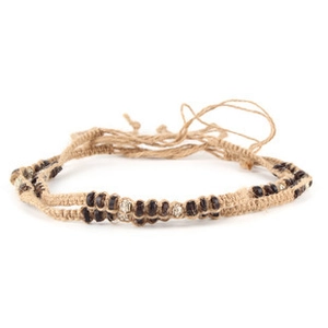 Close-up of ethnic style braided rope with dark wooden beads for DIY hat decoration