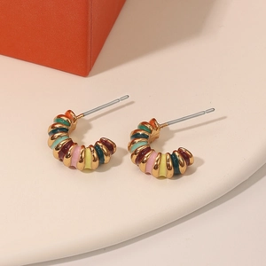 Colorful enamel C-shaped earrings in gold-plated metal with vibrant striped patterns