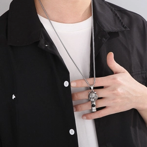 Men's silver steel lion head whistle pendant necklace shown on a male model