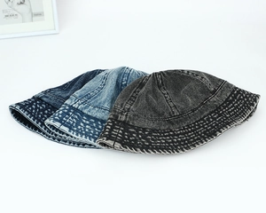 Three shades of washed denim bucket hats in navy, blue, and charcoal with quilted brims