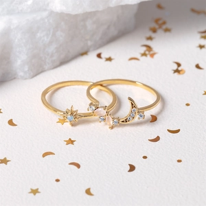 Star and moon gold ring set with blue opal and zircon stones on white background