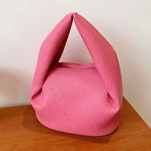 Pink pleated dumpling bag in pebbled leather with minimalist handle for women