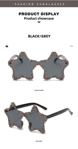 Detailed view of star-shaped sunglasses with hand-set rhinestones and dark grey lenses