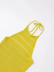 Detailed macro view of yellow knit texture and breathable mesh pattern of the halter top