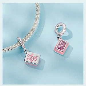 Detailed macro view of S925 sterling silver Mahjong pendant with pink stones and Fa carving