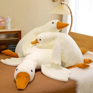 Detailed plush texture of white goose toy set with orange beak and feet in a cozy bedroom