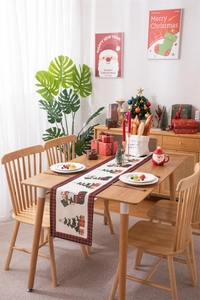 Detailed close-up of a festive Christmas table runner with red and black plaid borders