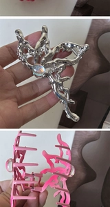 Detail of butterfly hair clips with sparkling rhinestones and elegant pearls in two colors
