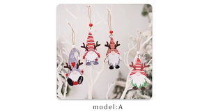 Detail of four wooden Christmas gnomes with reindeer antlers hanging on white branches