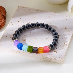 Macro shot of 8mm natural stone beaded bracelet with colorful cubic gems and silver spacers