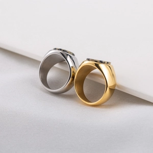 Minimalist 18K gold and silver signet rings with spotted stone inlay in a modern style