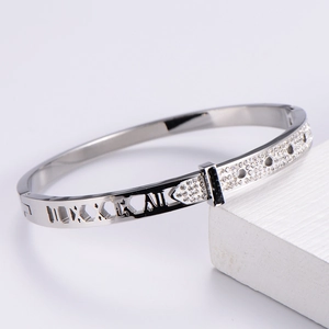 Macro view of silver hollow roman numeral bracelet with sparkling diamond-set buckle detail