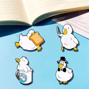 Set of 4 cute cartoon duck enamel pins with toast and knife motifs on blue background