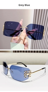 Detail view of grey blue gradient rimless sunglasses with gold flower metal hinge