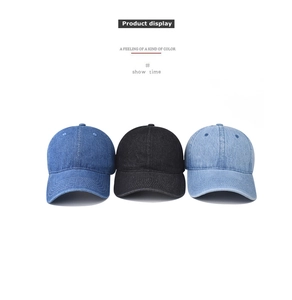Detailed view of classic washed denim baseball caps in dark blue, black, and light blue