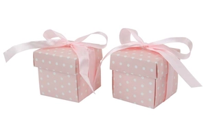Detail of pink polka dot paper gift boxes with satin bows for weddings and parties
