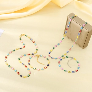 Colorful evil eye jewelry set with gold and silver necklaces and bracelets on beige fabric