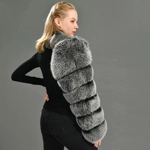 Close-up of grey faux fox fur coat featuring horizontal texture and fluffy material