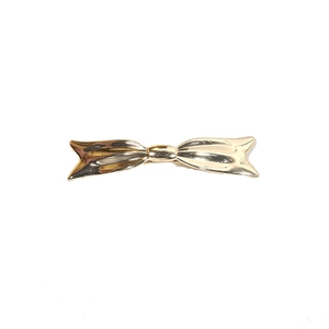 Elegant gold metal bow hair clip with a polished finish on a clean white background