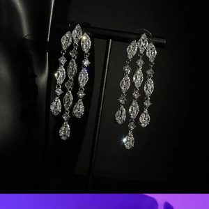 Detailed view of silver dangle fringe earrings with sparkling teardrop marquise zircons