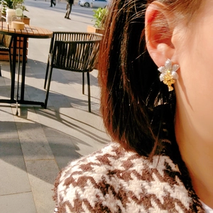 Luxury Asscher yellow diamond flower earrings in micro-paved silver worn by a model