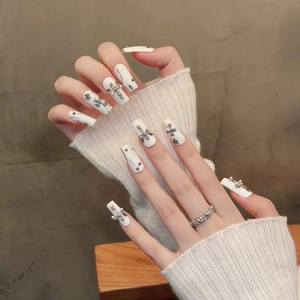 Gothic white coffin press-on nails featuring silver cross and pearl details with ring