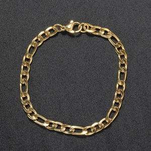 5mm gold Figaro chain bracelet in stainless steel with lobster clasp on black background