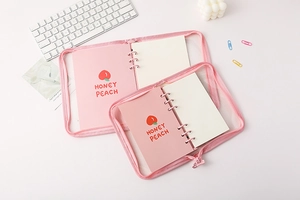 Detail of pink mesh PVC binder cover with zipper and honey peach cartoon pattern