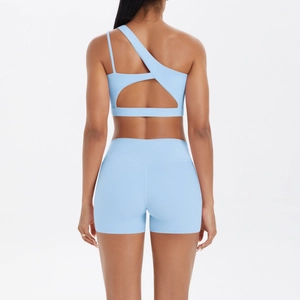 Back view of light blue one-shoulder sports bra and high-waist fitness shorts set