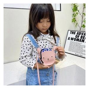 Detail of pink bear-shaped crossbody bag featuring textured PU leather and drawstring closure