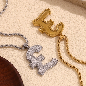 Detail of pound sign pendants in gold and silver finish with twisted chains