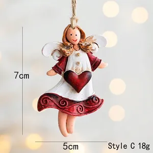 Detail view of resin angel ornament with red heart and twine, 7cm height dimensions