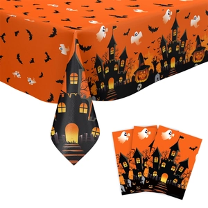 Detailed view of orange Halloween tablecloth featuring black haunted house and ghost patterns