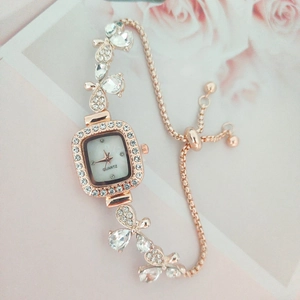 Detail of rose gold bracelet watch with crystal leaf accents and quartz movement